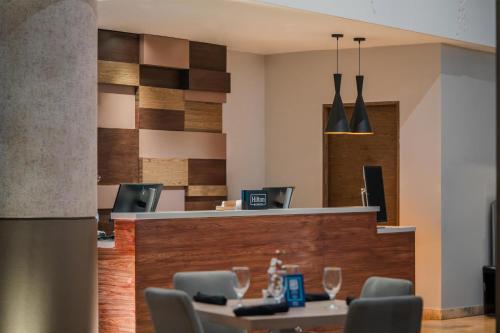 a lobby with a bar with chairs and wine glasses at Doubletree By Hilton Mexico City Santa Fe in Mexico City
