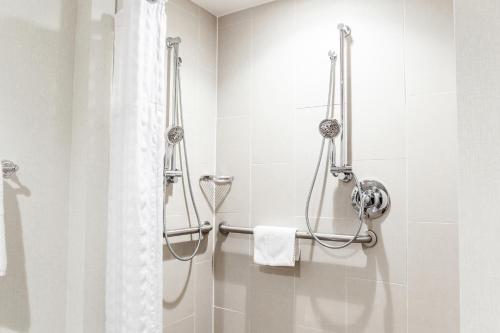 a bathroom with a shower with a white shower curtain at Doubletree by Hilton Pleasant Prairie Kenosha, WI in Pleasant Prairie