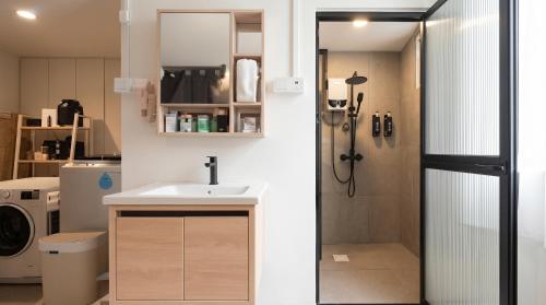 a bathroom with a sink and a shower at CoZzzee Hostel in Singapore