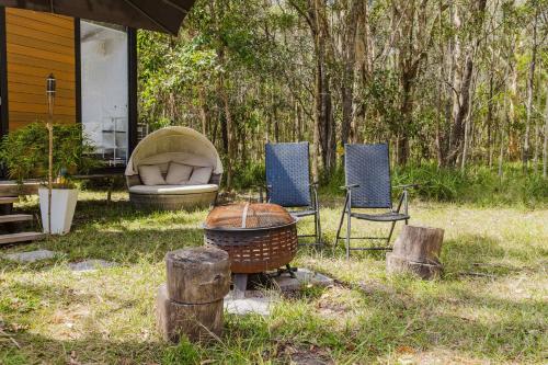 a group of chairs and a couch in a yard at Clarence Farm Stay by Tiny Away in Maclean