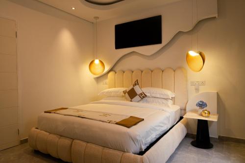 a bedroom with a large bed and a flat screen tv at 18 On OniX Lodge & Spa - World Class in Four Ways