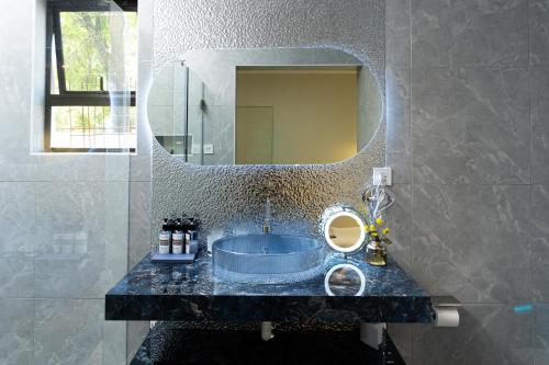 a bathroom with a sink and a mirror at 18 On OniX Lodge & Spa - World Class in Four Ways