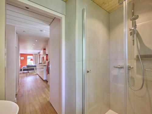 a shower with a glass door in a bathroom at Huisje Joep in Goedereede