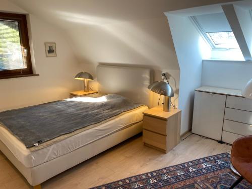 a bedroom with a bed and two lamps on tables at Villa Bellevue Apartment 1 Deluxe Apartment in Ossiach
