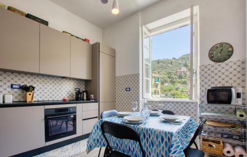 a kitchen with a table with a blue tablecloth on it at Casa Garibotti in Recco