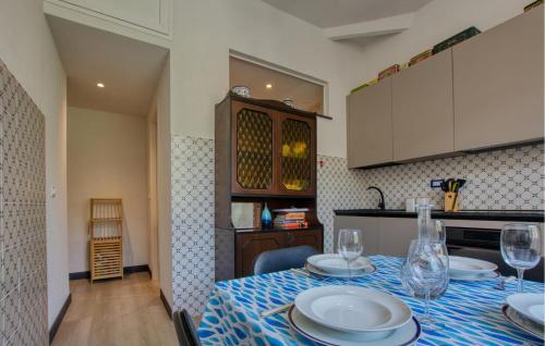a kitchen with a table with plates and wine glasses at Casa Garibotti in Recco