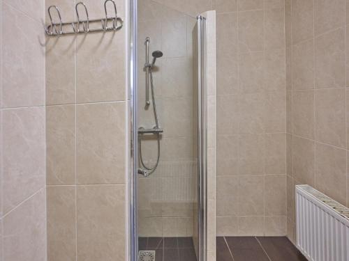 a shower with a glass door in a bathroom at Heidepracht in Putten