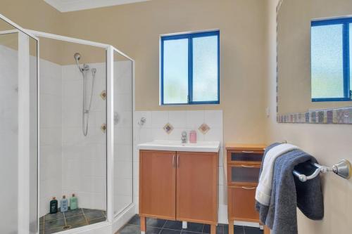 a bathroom with a shower and a sink at The Zoo House in Broome
