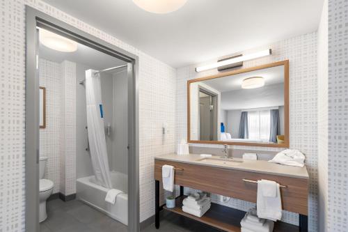 a bathroom with a sink and a toilet and a mirror at Hampton Inn & Suites New Castle, PA in New Castle