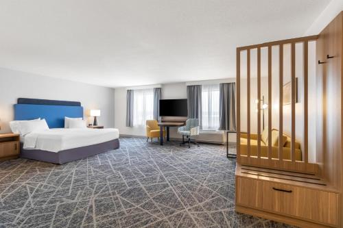 a hotel room with a bed and a desk at Hampton Inn & Suites New Castle, PA in New Castle