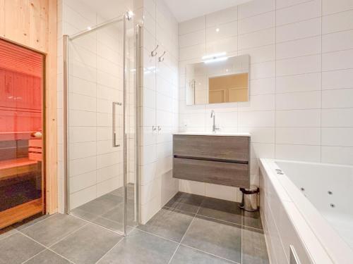 a bathroom with a shower and a sink and a tub at Garden de luxe 27B in Colijnsplaat
