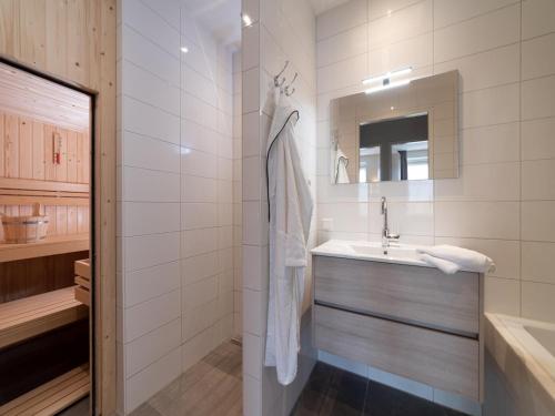 a bathroom with a sink and a mirror at La Mer Luxe in Colijnsplaat