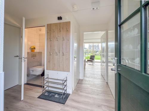 a hallway with a bathroom with a toilet and a door at Coast and Calm 63 in Colijnsplaat