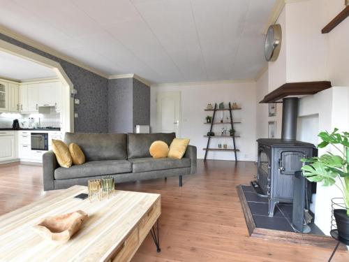a living room with a couch and a wood stove at t Kaatsheuveltje 2 in Kaatsheuvel