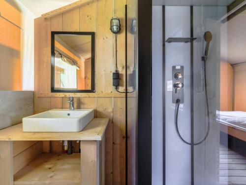 a bathroom with a sink and a shower at Safaritent 6 in Vessem