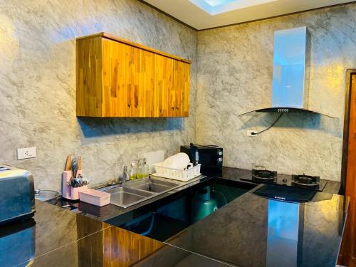 a kitchen with a sink and a counter top at Thawat Villa Boutique Resort in Ko Lanta