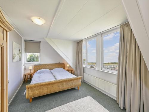 a bedroom with a bed and a large window at Rose Garden in Stevensweert