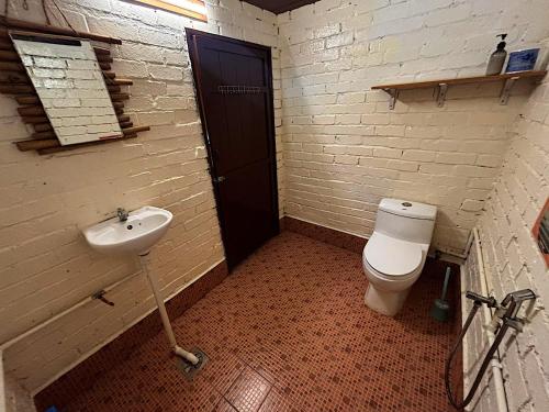 a bathroom with a sink and a toilet at Home Sol Guesthouse in Pantai Cenang
