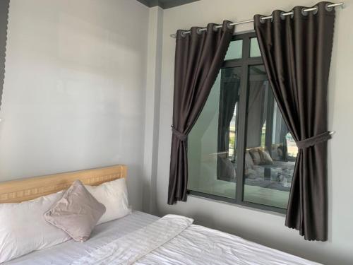 a bedroom with a bed and a window at Du mục stay in Ninh Hải
