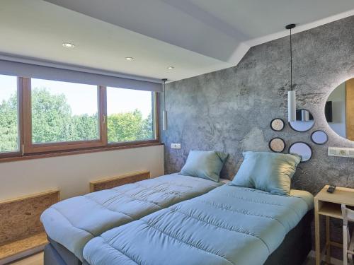 two beds in a room with two windows at Silt in Schinnen