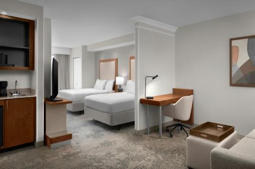 a hotel room with two beds and a desk at SpringHill Suites by Marriott Lynchburg Airport/University Area in Lynchburg