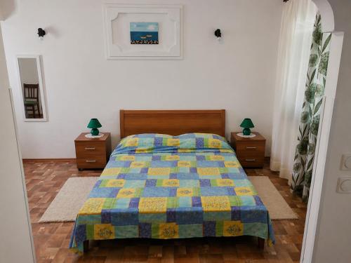 a bedroom with a bed and two night stands at Ina in Funtana