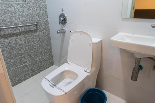 a bathroom with a toilet and a sink and a shower at Hotel Sogo Sta Rosa in Santa Rosa