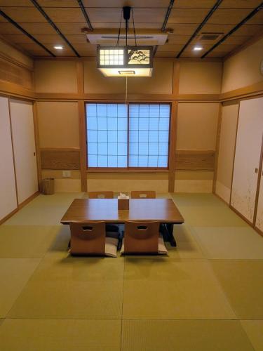 a large room with a wooden table and chairs at 和の貸切宿yanagiya in Daisen