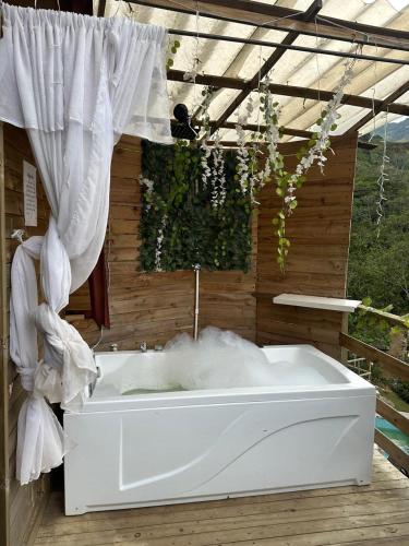 a white bath tub sitting in front of a window at Finca la Cabaña in Cisneros