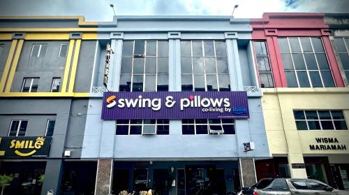 a building with a sign on the front of it at Swing & Pillows - Sentul Titiwangsa in Kuala Lumpur