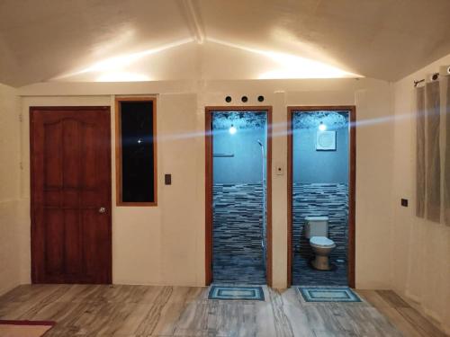 an empty room with a toilet and a door at Gratum Beach 1 & 2 Resorts Glamping in Dapitan