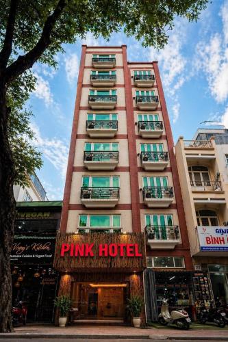 a tall building with a pink hotel sign on it at Pink Boutique Ben Thanh Hotel in Ho Chi Minh City