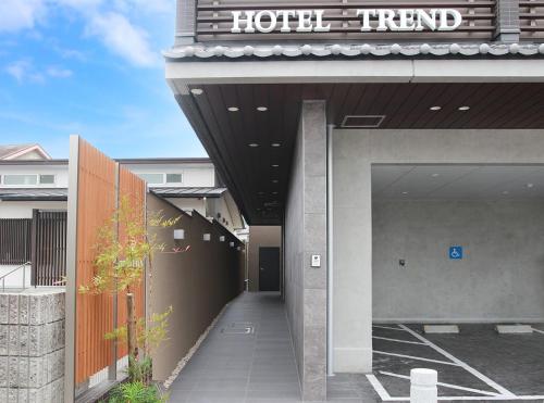 a hotel entry to a building with a sign on it at Hotel Trend JR Uji Ekimae in Uji
