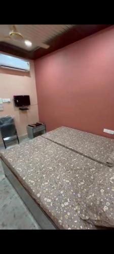 a bed in a room with a table and chairs at Shree ram lodge in Maihar