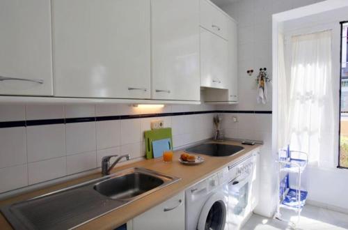 a kitchen with a sink and a washing machine at Casa El Capricho in Marbella
