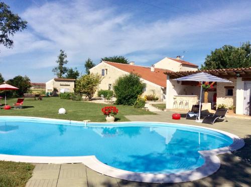 a swimming pool in the yard of a house at Le Clos du Plantis in Sonnac