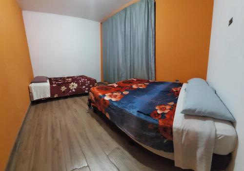 a bedroom with two beds in a room at Las Armonías Hostal in Panajachel