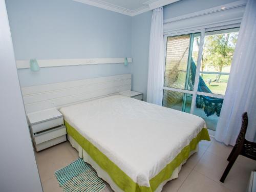 En eller flere senger på et rom på Residencial Villa Lobos