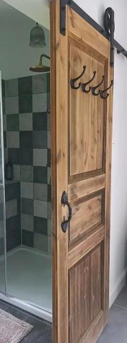 a wooden door in a bathroom with a shower at Heimat in Karstädt