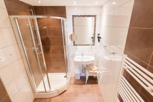 a bathroom with a shower and a sink at Haus Christophorus in Mariapfarr