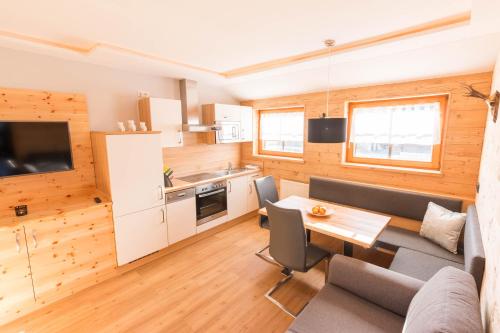 a kitchen and living room with a table and chairs at Haus Christophorus in Mariapfarr