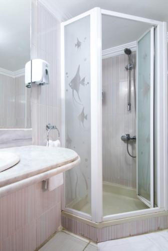 a bathroom with a shower with a glass door at Monte Cairo Serviced Apartments in Cairo