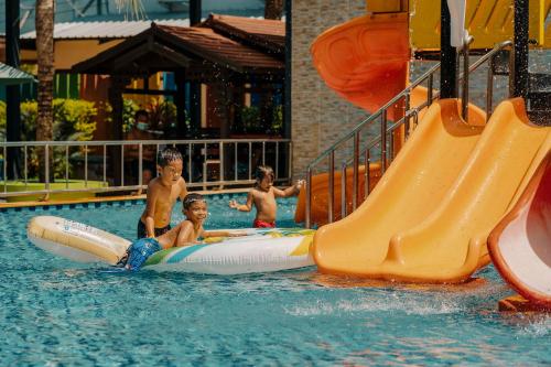 a group of young boys playing on a water slide at Rawayana Villas in Rawai Beach