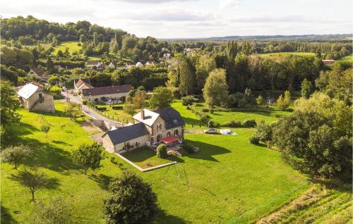 an aerial view of a house on a green field at Grange En Campagne in Vauxaillon