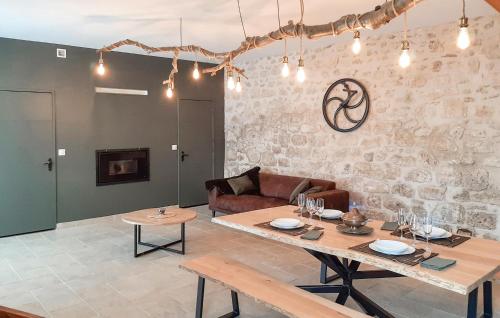 a living room with a table and a couch at Grange En Campagne in Vauxaillon