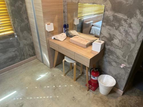 a bathroom with a desk with a mirror and a sink at Osoha guest house in Samcheok