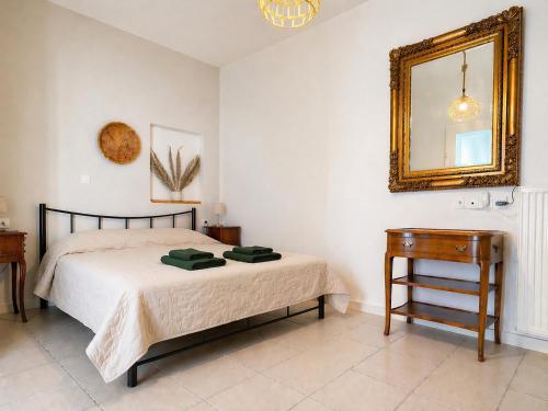a bedroom with a bed and a mirror and a table at Milky house Vrachati in Vrachati