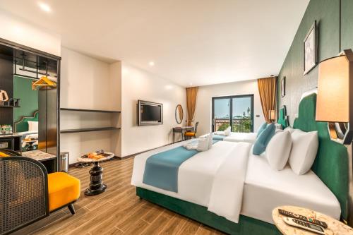 a hotel room with a large bed and a desk at Dream Future VangVieng Hotel in Vang Vieng