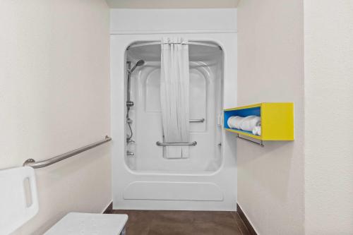 a bathroom with a glass shower in a toilet at Days Inn by Wyndham San Francisco S/Oyster Point Airport in South San Francisco