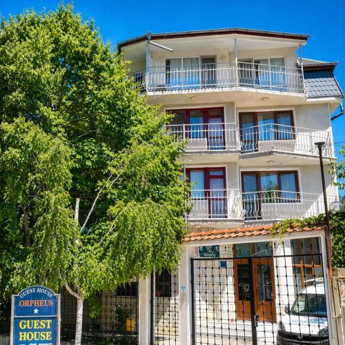 a tall white building with a guest house at Guest House Orfey in Kranevo